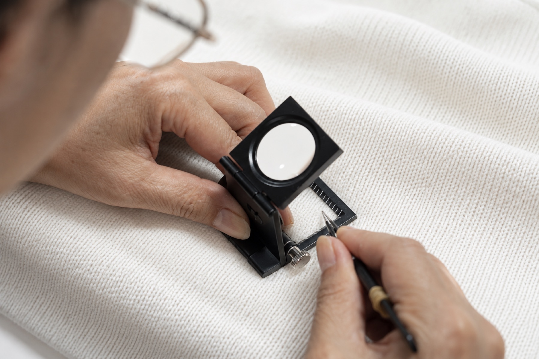 A finished knit garment undergoing quality inspection